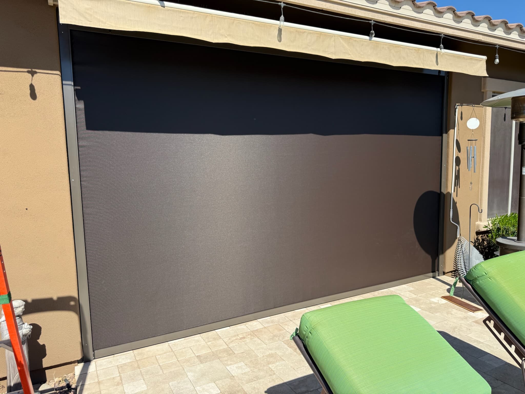 Outdoor patio screen lowered for privacy on a Phoenix pool patio