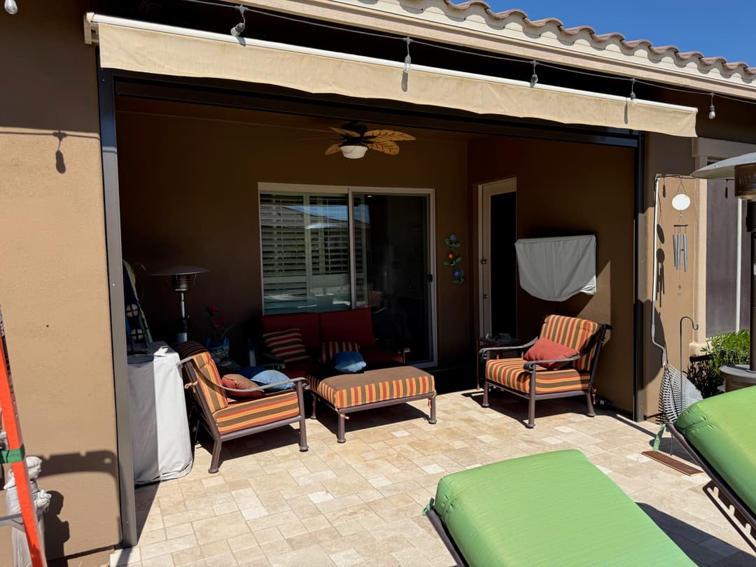 Black retained patio shade raised on a Phoenix pool patio