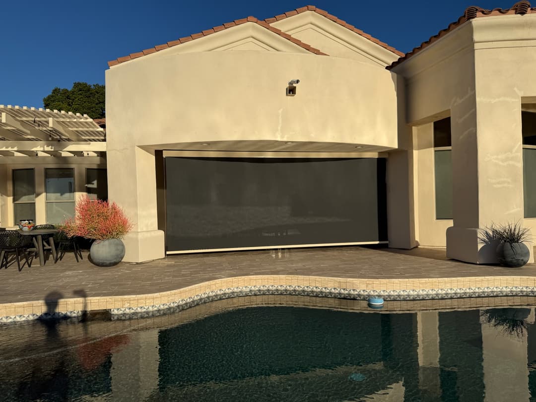Large cable-guided poolside shade installed on a Phoenix patio