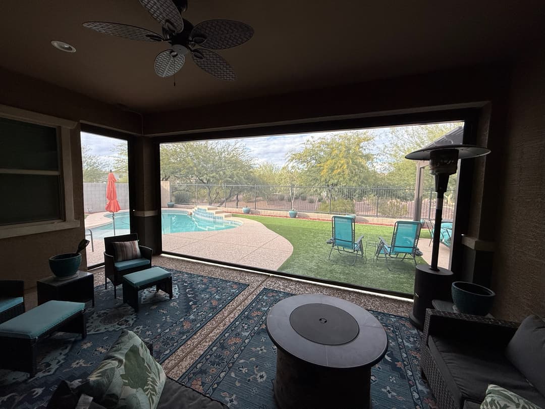 View from a shaded Phoenix patio toward a backyard pool
