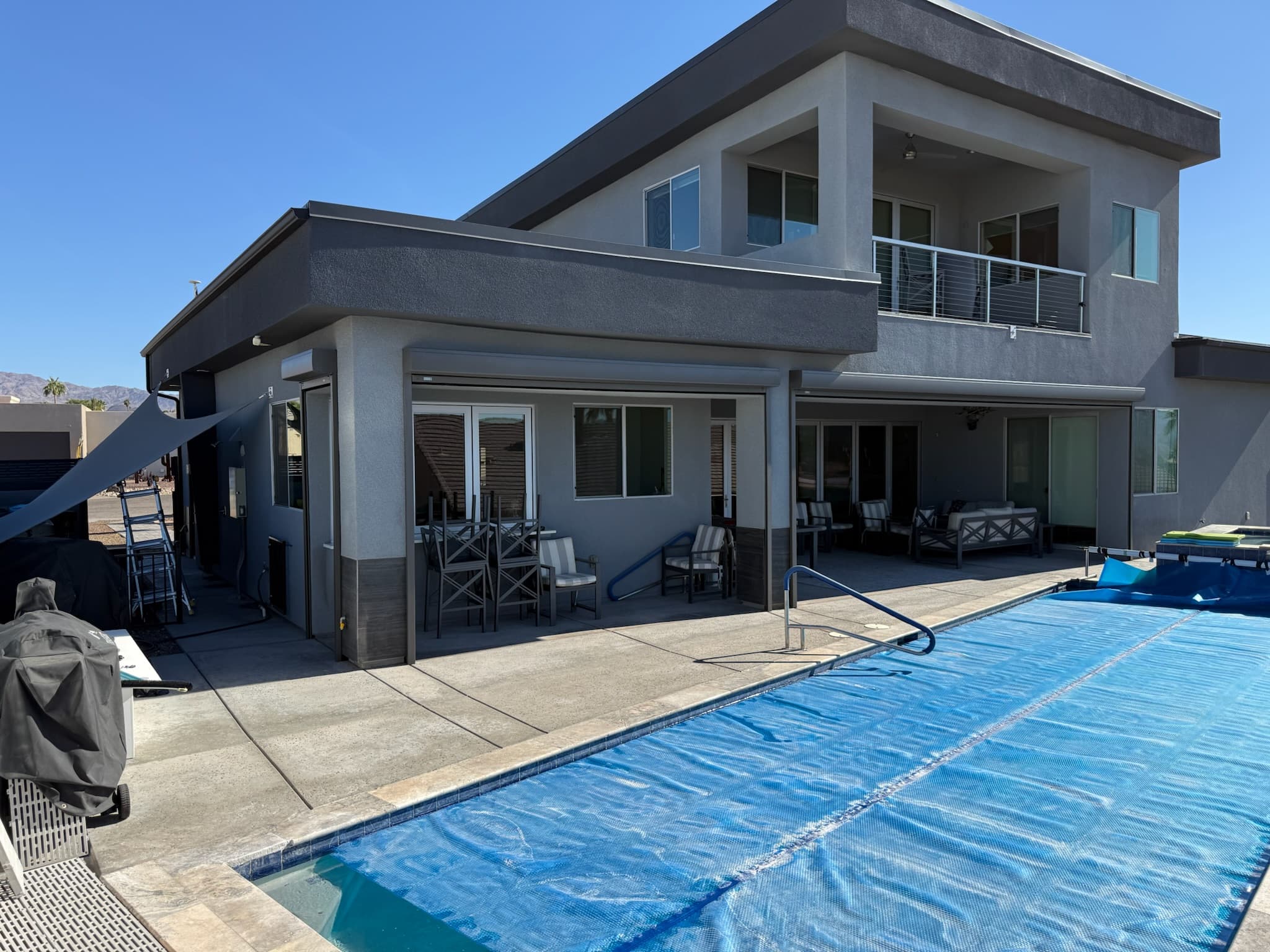 Poolside patio shades raised on the same Phoenix home