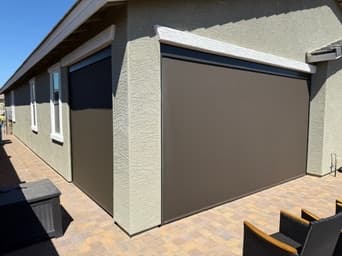 Screen shades installed around the corner of a covered Phoenix patio