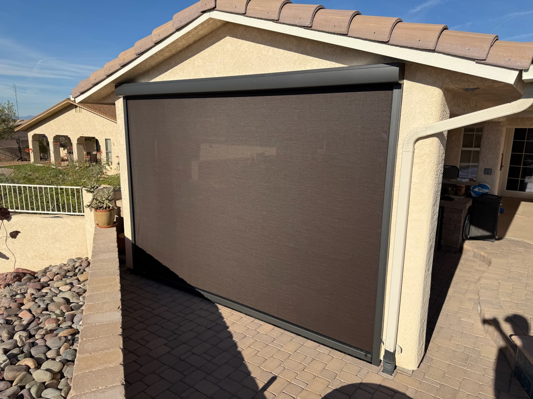 Large motorized roll shade lowered on a Phoenix patio