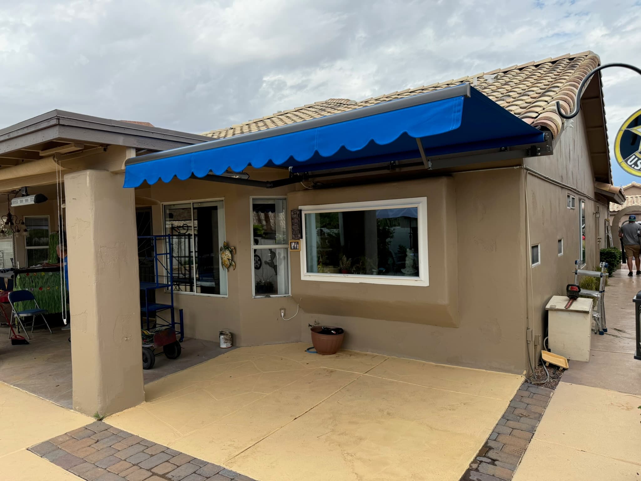 Blue retractable awning extending the usable patio space at a Phoenix home