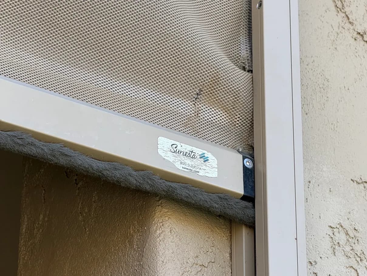 Jammed exterior shade bottom bar showing why diagnosis-first repair matters