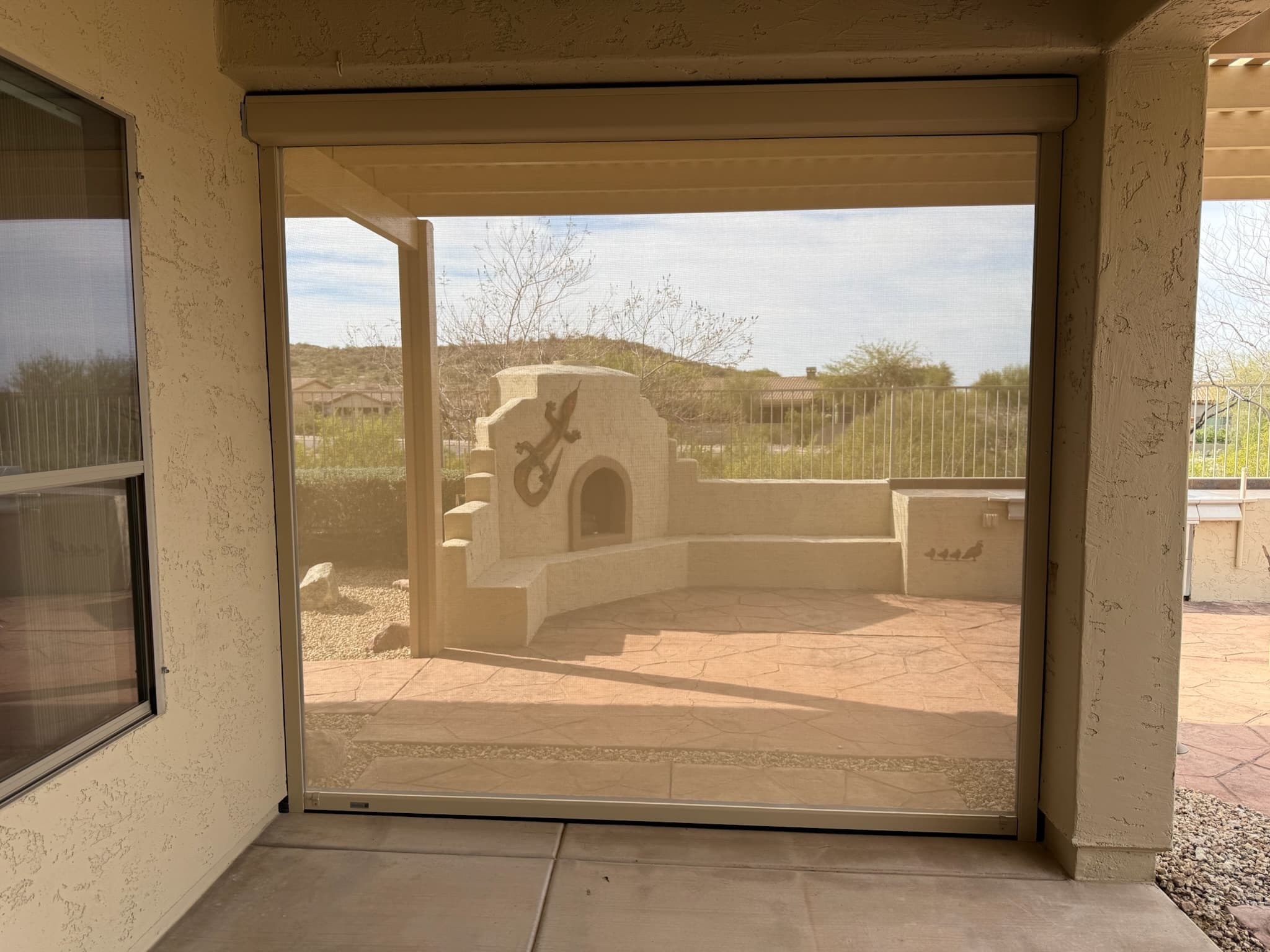 Custom patio roll shades lowered on a Phoenix backyard patio
