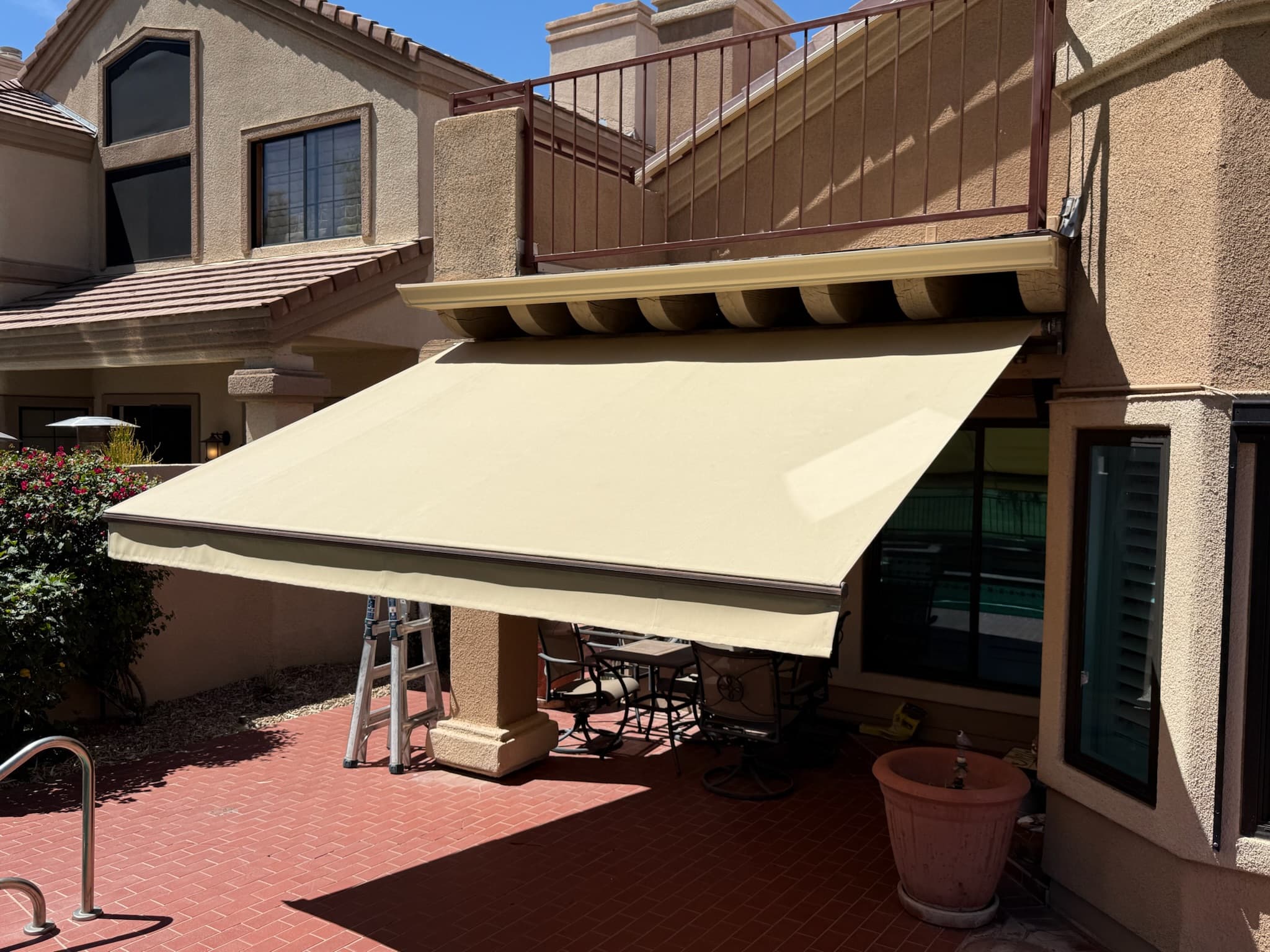 Retractable awning receiving adjustment and service